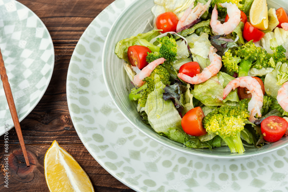 Bowl of salad with broccoli and shrimp. Bowl of salad with broccoli and shrimp.