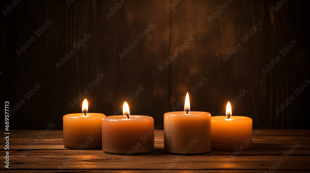 Three burning candles on a table
