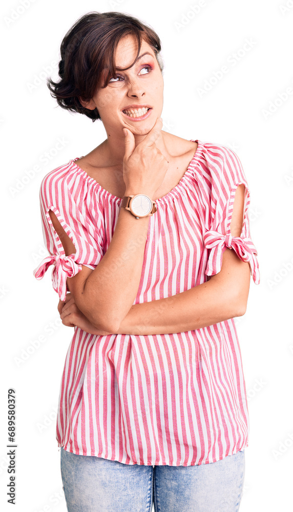 Beautiful young woman with short hair wearing casual summer clothes thinking worried about a question, concerned and nervous with hand on chin Beautiful young woman with short hair wearing casual summer clothes thinking worried about a question, concerned and nervous with hand on chin