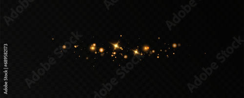 Golden sequins glow with many lights. Glittering dust. Luxurious background of golden particles.