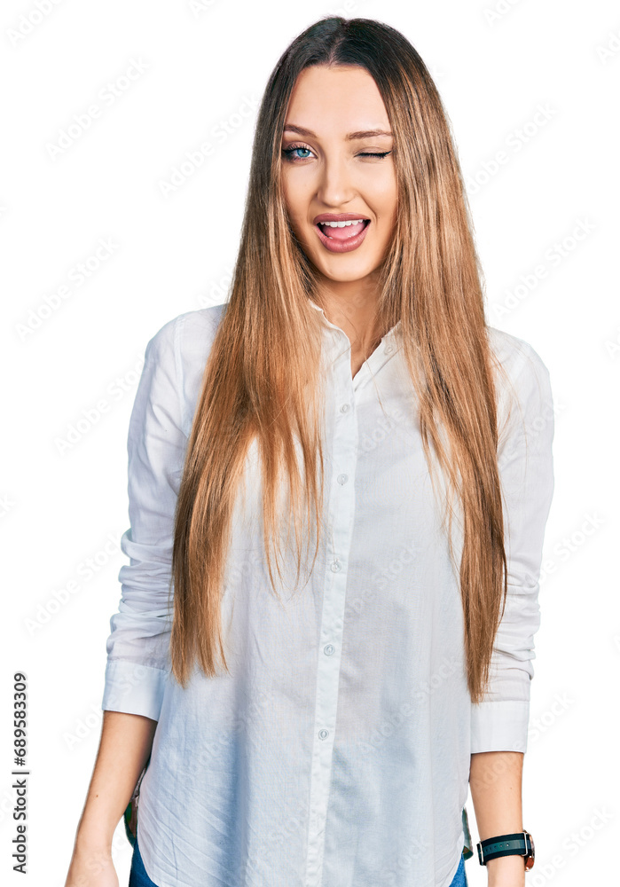 Beautiful caucasian woman wearing casual white shirt winking looking at the camera with sexy expression, cheerful and happy face. Beautiful caucasian woman wearing casual white shirt winking looking at the camera with sexy expression, cheerful and happy face.