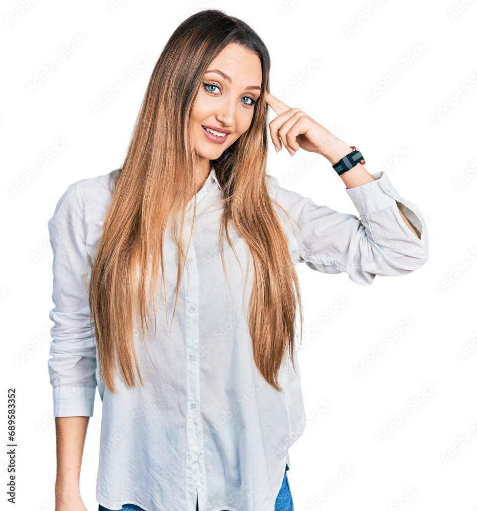 Beautiful caucasian woman wearing casual white shirt smiling pointing to head with one finger, great idea or thought, good memory Beautiful caucasian woman wearing casual white shirt smiling pointing to head with one finger, great idea or thought, good memory