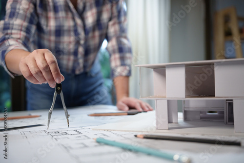 Architecture drawing on architectural project business architecture building construction Colleagues designer Planning Design on blueprint with compasses