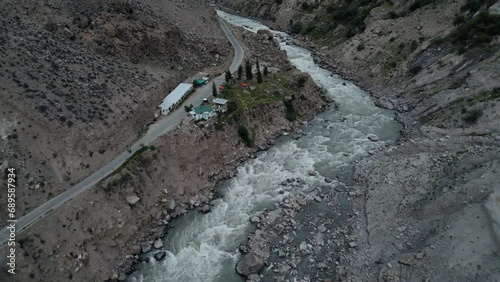 Aerial drone view of road along with Astore river in Karakoram Range in Himalayas mountains near Astore Valley along Karakoram Highway Gilgit Baltistan Pakistan
