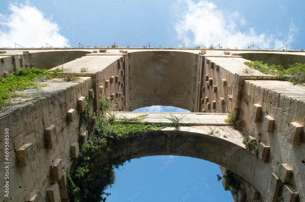 Arches of old stone bridge Ponte Vecchio or Padre Scopetta in Ragusa seen from below, Sicily, Italy