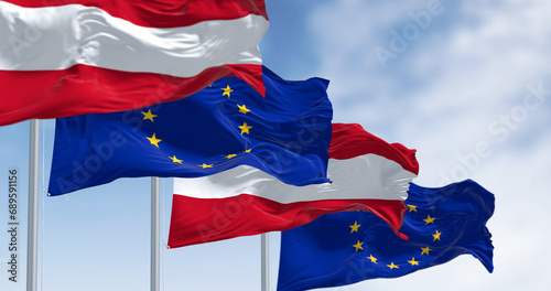 Austria and European Union flags waving together on a clear day