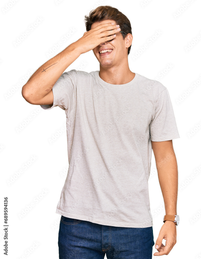 Handsome caucasian man wearing casual clothes and glasses smiling and laughing with hand on face covering eyes for surprise. blind concept. Handsome caucasian man wearing casual clothes and glasses smiling and laughing with hand on face covering eyes for surprise. blind concept.