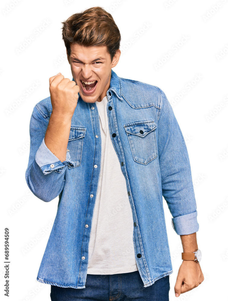 Handsome caucasian man wearing casual denim jacket angry and mad raising fist frustrated and furious while shouting with anger. rage and aggressive concept.