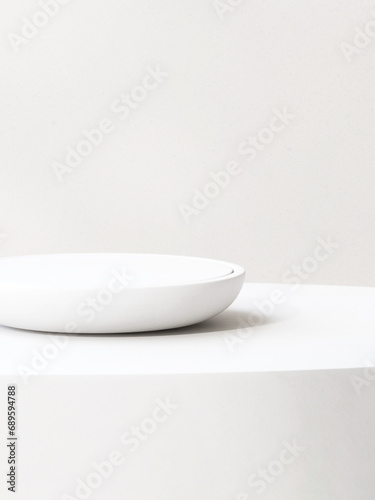 Modern round white plate shape podium on table counter in sunlight for luxury organic cosmetic  skincare  beauty  body  hair care  treatment  fashion product display background 3D