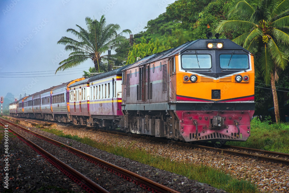 Fototapeta premium Passenger train by diesel locomotive on the railway.