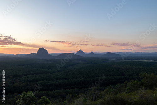 Tourists visit the Wildhorse scenic lookout for sunset panoramic views across the Glasshouse Mountains and the Sunshine Coast in Queensland