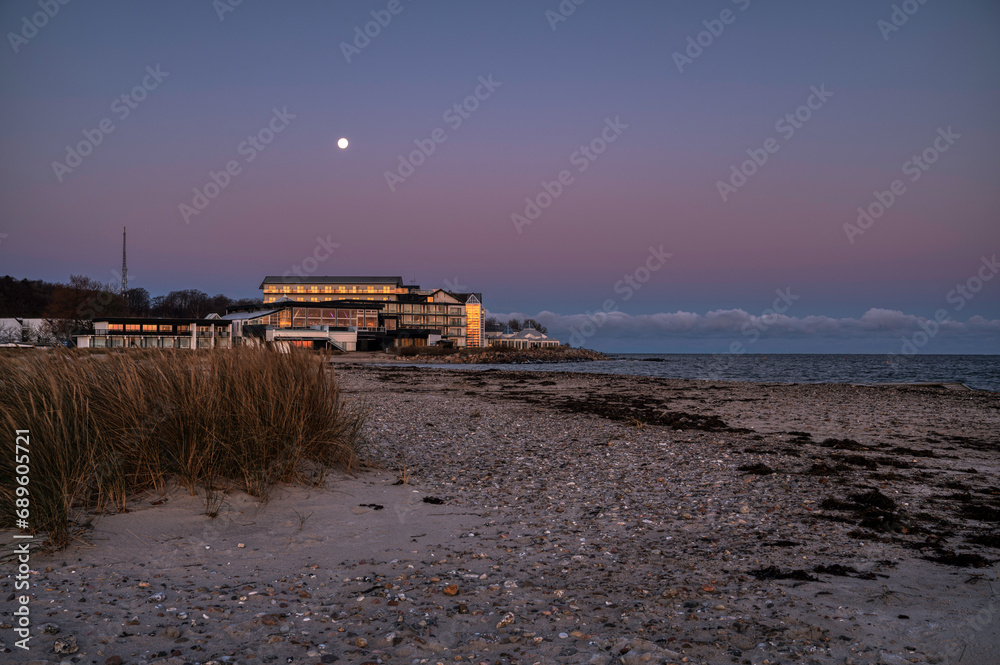 the romantic Marienlyst beach hotel in moonlight during the twilight hour