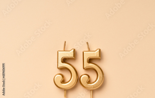 55 years celebration festive background made with golden candles in the form of number fifty-five. Universal holiday banner with copy space.