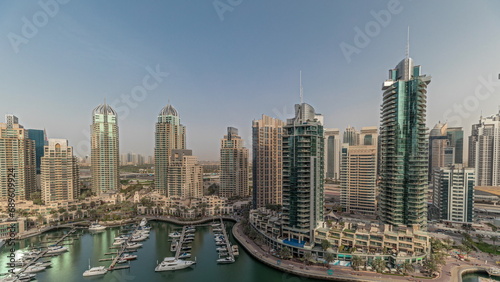 Panorama showing Dubai marina tallest skyscrapers and yachts in harbor aerial timelapse.