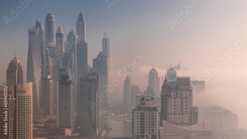 View of various skyscrapers in tallest residential block in Dubai Marina aerial timelapse