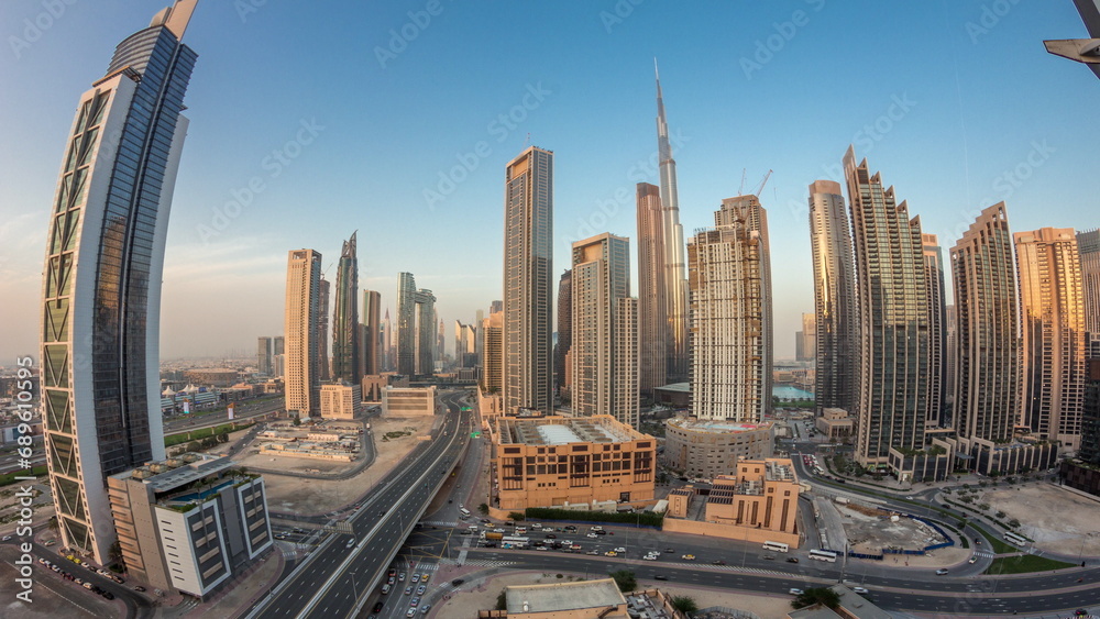 Aerial view of Dubai Downtown skyline with many towers day to night timelapse.