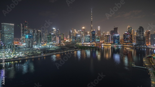 Panorama showing aerial view to Dubai Business Bay and Downtown with the various skyscrapers and towers night timelapse
