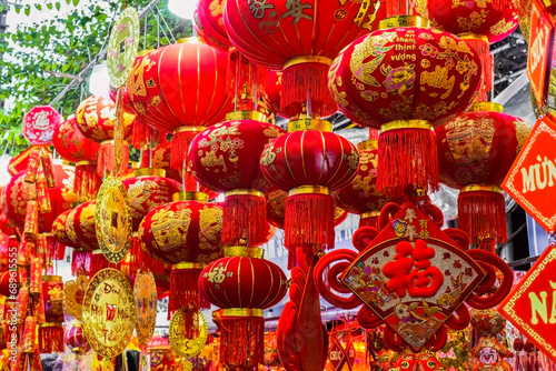  Many red lanterns with vietnamese language translated as "Happy New Year" hanging in Vietnam for Tet Lunar New Year