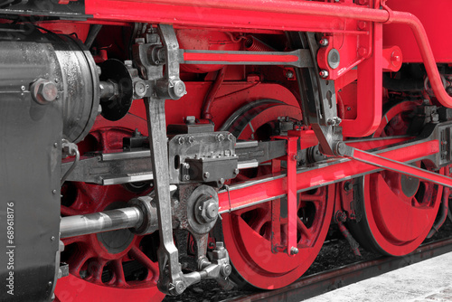 Close-up of red wheels of an old steam train locomotive