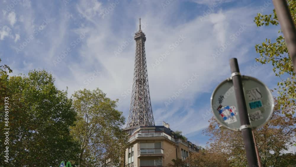 edificios de varias plantas en una calle de parís y atrás la torre Eiffel