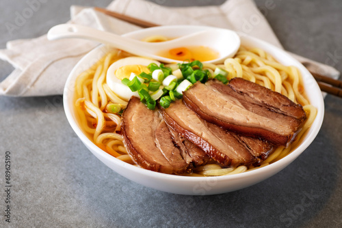 Asian ramen noodles soup with egg, pork and onion.