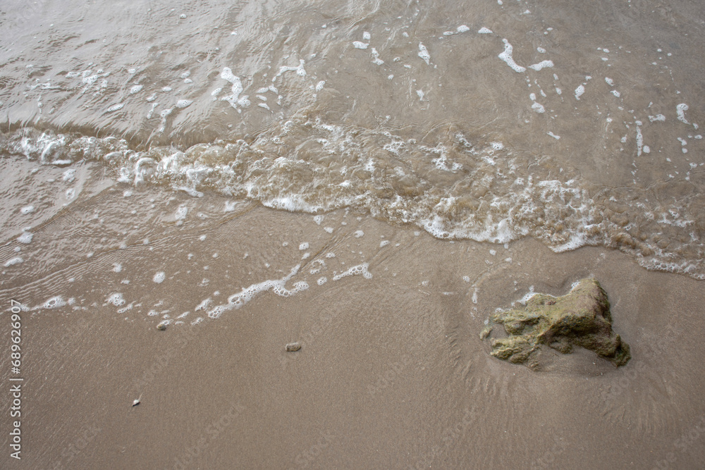 Close up sea water waves with bubbles