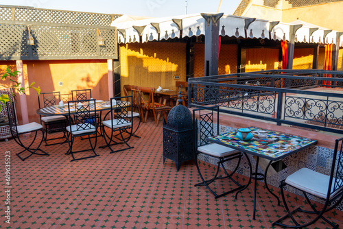 Upper terrace of a Riad.
Typical Moroccan house, with lots of decoration on the terrace. Sunny morning.
