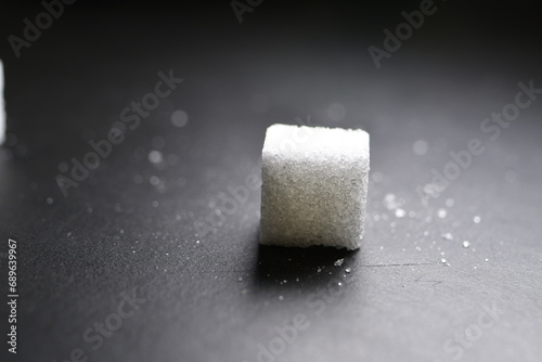 Sugar cubes black Background background iluminated sweet food photo