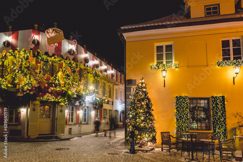 Beautiful cozy Christmas decorations and lights in the old town of Vilnius, capital of Lithuania, Europe, by night