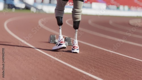 Asian para-athletes with prosthetic blades sprint on a running track at stadium. photo