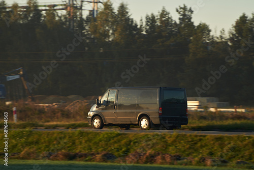 Commercial van delivers cargo to suburban custmers. Shipping parcels goods and orders in the countryside. Light duty truck © AlexGo