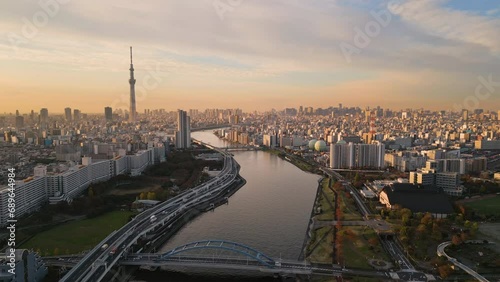 tokyo city aerial view drone of skytree tower asakusa district at sunrise,flying over sumida river modern building and skyscrapers skyline in the background at dawn photo