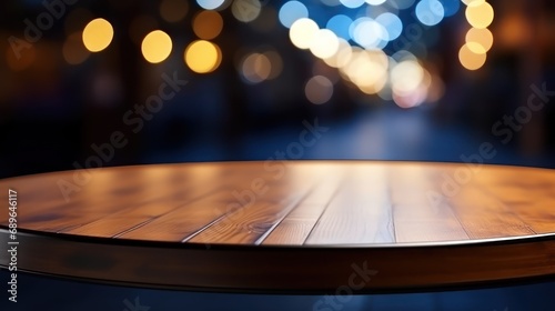 The empty wooden table top with blur background of restaurant at night. Exuberant image. 