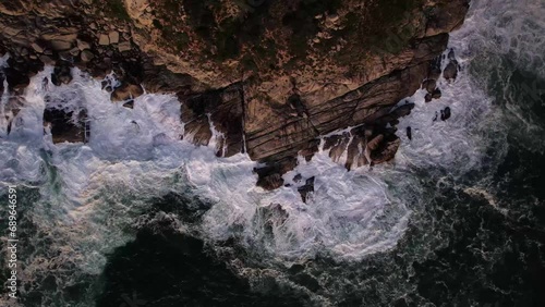 Aerial view of waves breaking along the coastline at Cape of Good Hope National Park and Natural Reserve, Cape Town, Western Cape, South Africa. photo
