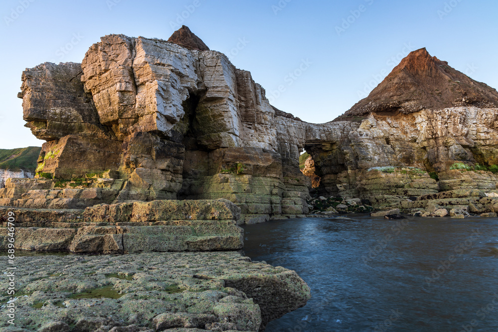 Thornwick Nab sea stack and arch at Thornwick Bay on the Yorkshire Coast. Taken at sunrise.	