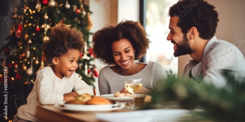 Happy little baby boy and diverse family in a christmas dinner in a modern home photo