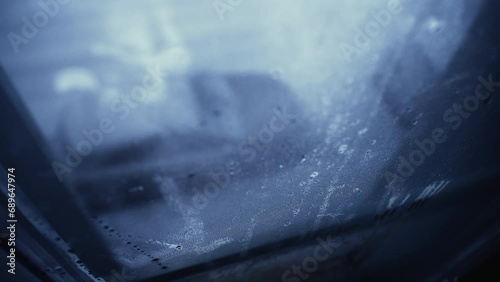 Winter Window Condensation on Moody Day, Depression Concept. Melancholic theme of person POV stuck at home apartment looking outside photo