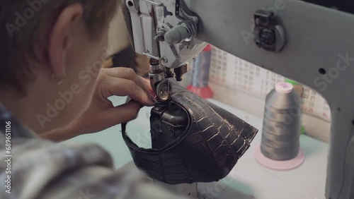 Elderly woman seamstress works remotely at home during quarantine