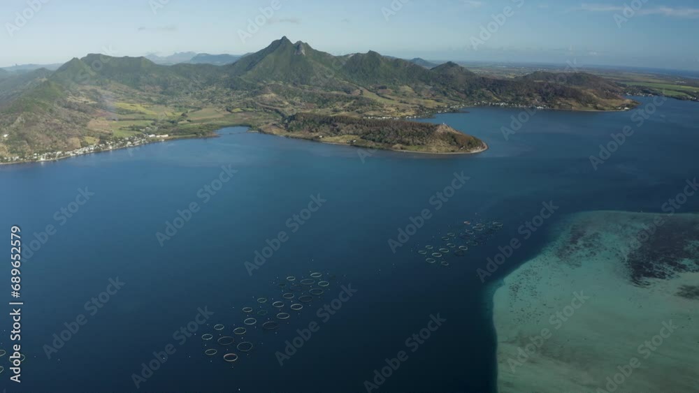 Aerial view of fish farm off the coastline with mountains in background, Grand Sable, Flacq District, Mauritius. Aerial view of fish farm off the coastline with mountains in background, Grand Sable, Flacq District, Mauritius.