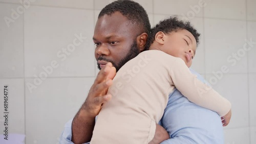 Loving African American dad embracing baby and baby girl sleeping on stepfather shoulder. Happy family with pleasure spending time at home, Being a father and Fatherhood family love relationship photo