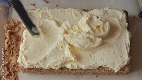 Cake making. Cream mousse. The pastry chef decorates the cake with cream mousse