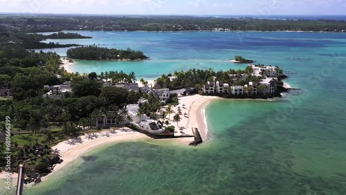 Aerial view of luxury resort Shangri-La Le Touessrok at noon with island, beach and mountains in the background, Flacq, Mauritius. photo
