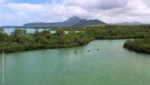 Aerial view of people kayaking in the mangroves with mountains in the background, ShangriLa Le Touessrok, Flac, Mauritius. photo