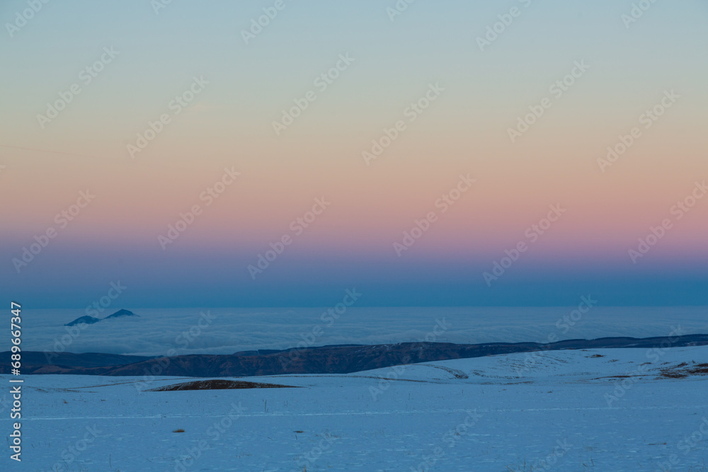 Sunset in snowy valley in Caucasus mountains, Russia. Background Sunset in snowy valley in Caucasus mountains, Russia. Background