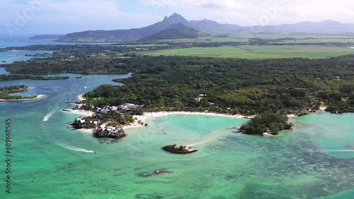 Panoramic aerial view of ShangriLa Le Touessrok and Ilot Mangenie with sailing boats and mountains in the background, Flacq, Mauritius. photo