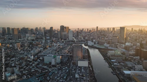 osaka business city aerial view drone at sunrise flying to umeda financial and transportation district hub,modern building and skyscrapers in the background at dawn photo