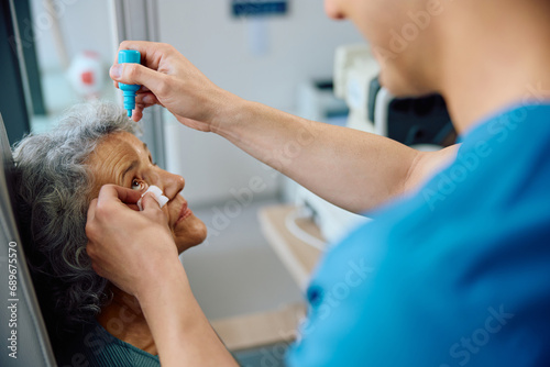 Cuadro en lienzo Senior woman having pupil dilation during eyesight exam at ophthalmologist