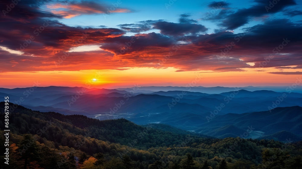 A ravine is reflected by the mountain range during a multicolored sunset.