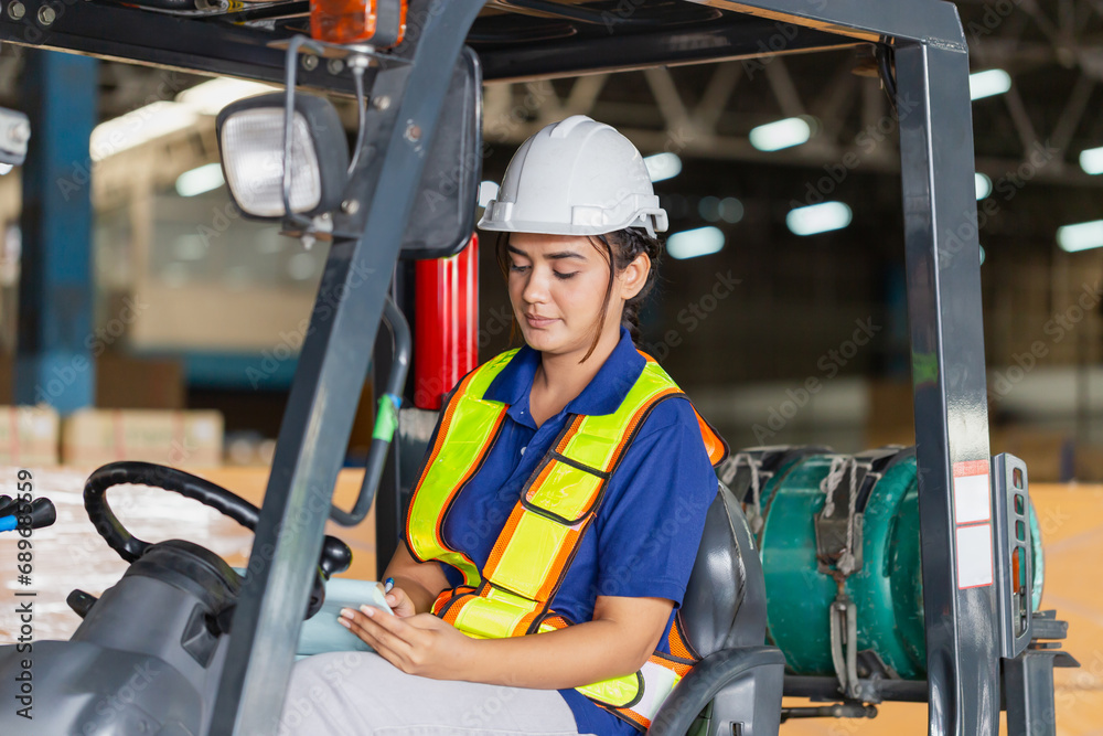 Female worker on forklift, Manual workers working in warehouse, Worker driver at warehouse forklift loader works Female worker on forklift, Manual workers working in warehouse, Worker driver at warehouse forklift loader works