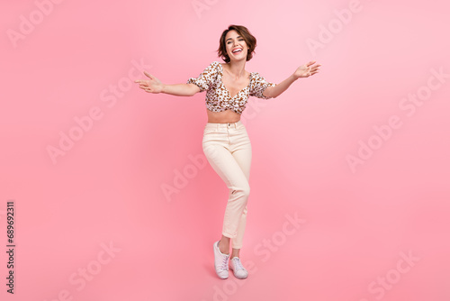 Full length portrait of stunning positive person raise opened arms welcome invite you isolated on pink color background